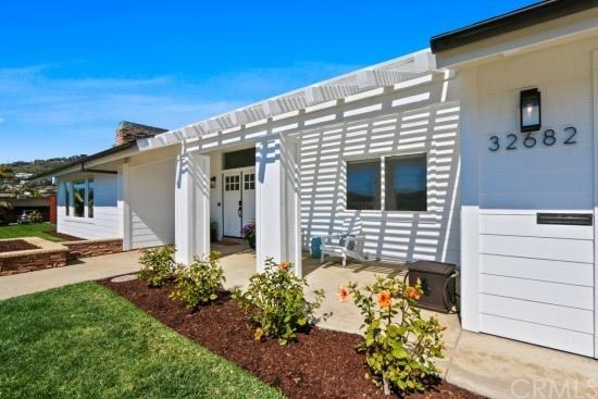 Newly remodeled front elevation of the beach close charming single level.