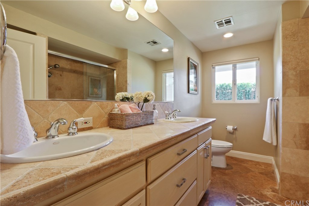 32682 7 Seas Drive Dana Point, CA 92629 - Photo 27 of 32 Full guest bath with tub & shower with great use of imported natural stones.