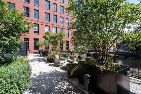 a view of a chairs and tables in the patio in front of a house