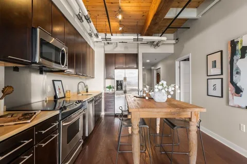 a kitchen with stainless steel appliances granite countertop a stove and a sink