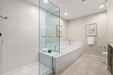 a bathroom with a tub a sink and a shower