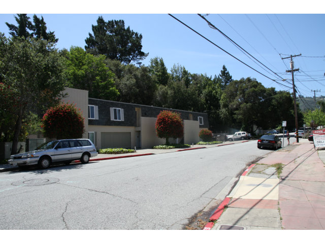 a view of street with parked cars