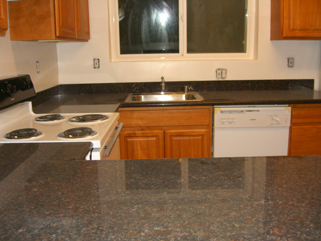 17 Devonshire Boulevard San Carlos, CA 94070 - Photo 12 of 25 a view of a kitchen with granite countertop white cabinets and black appliances