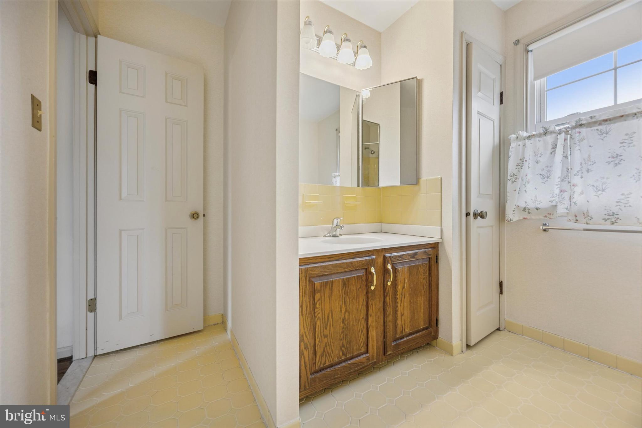 9 Hansen Court Narberth, PA 19072 - Photo 15 of 29 a bathroom with a granite countertop sink and a mirror