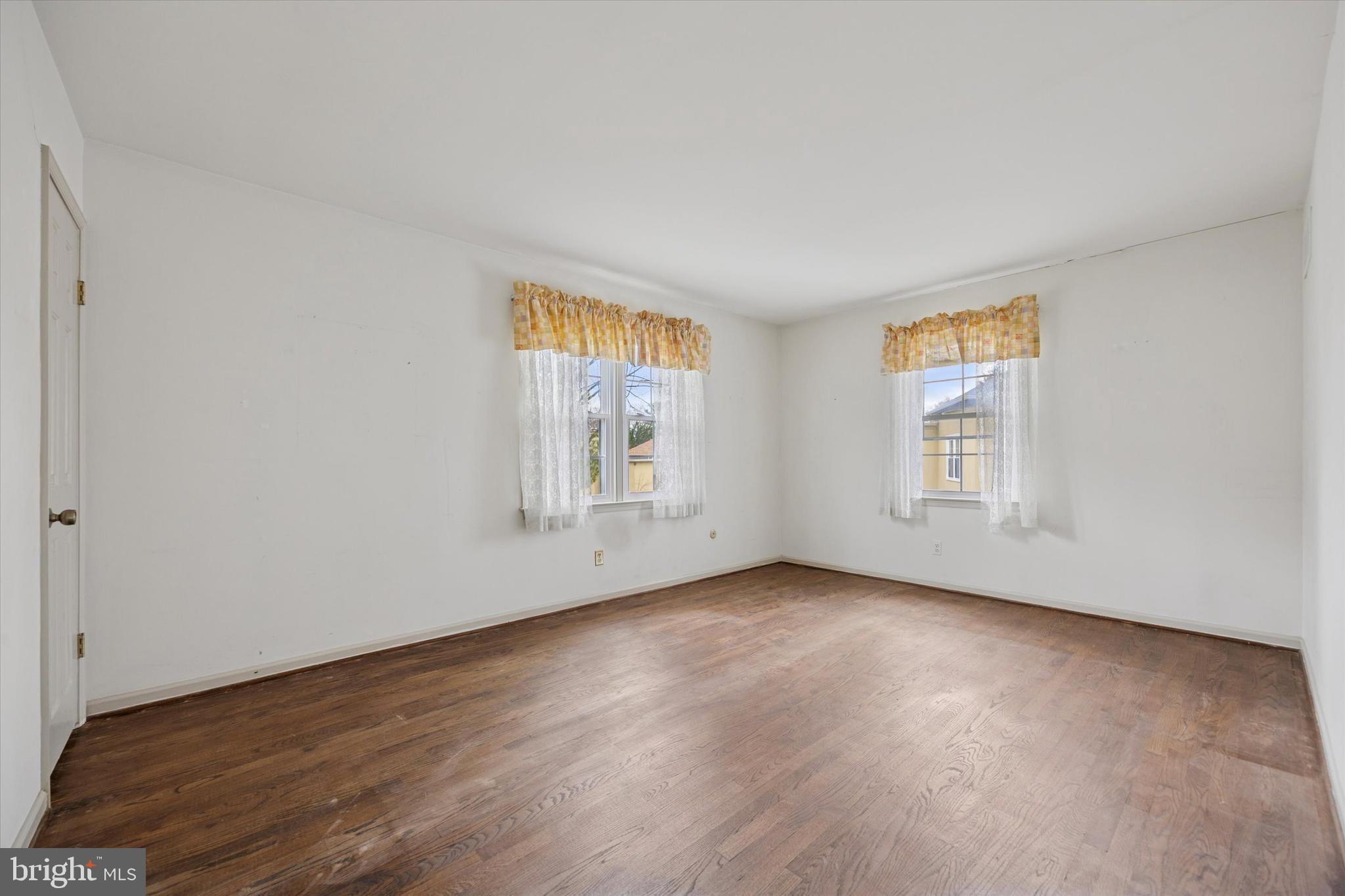 9 Hansen Court Narberth, PA 19072 - Photo 18 of 29 an empty room with wooden floor and windows
