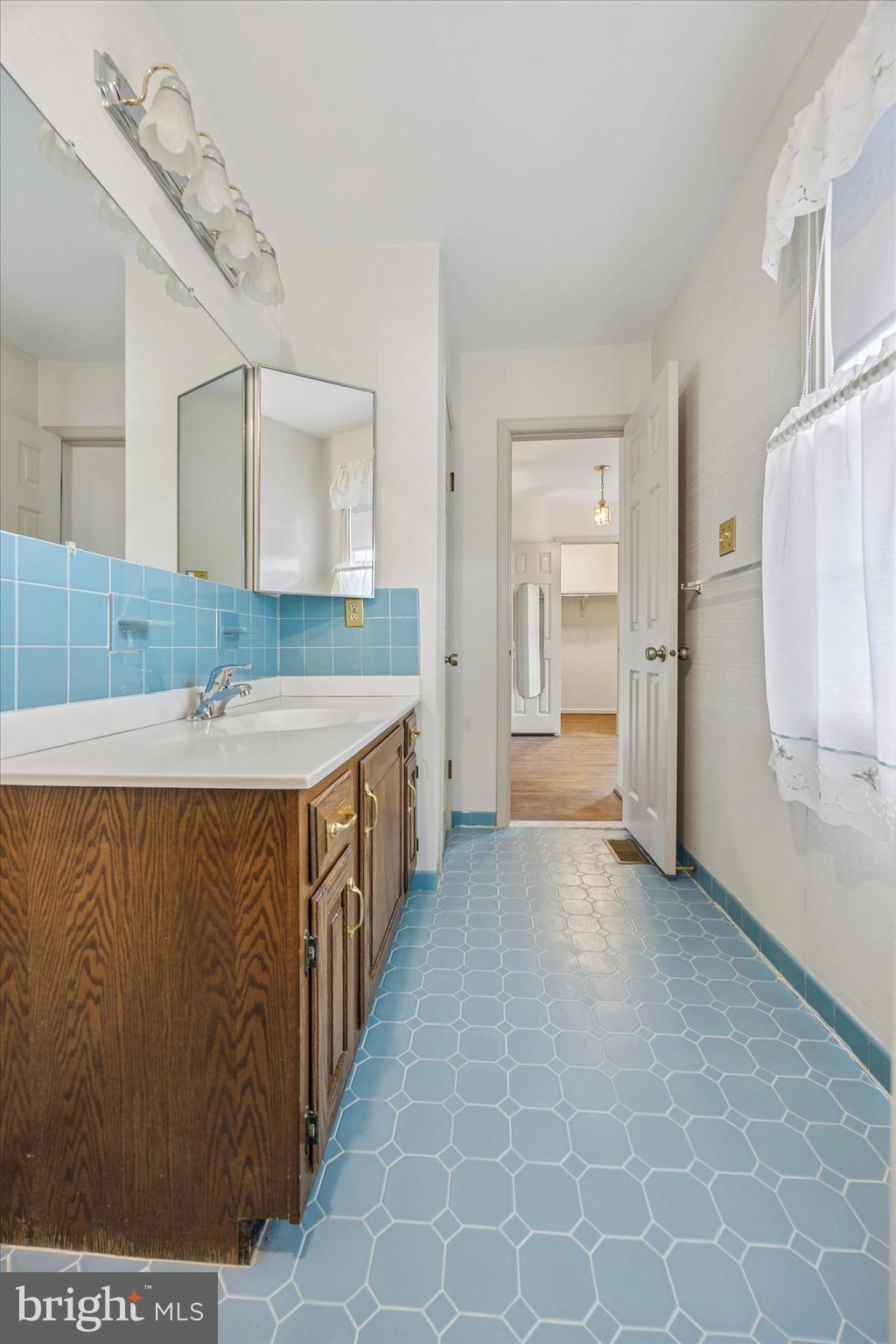 9 Hansen Court Narberth, PA 19072 - Photo 23 of 29 a bathroom with a double vanity sink a mirror and a bathtub