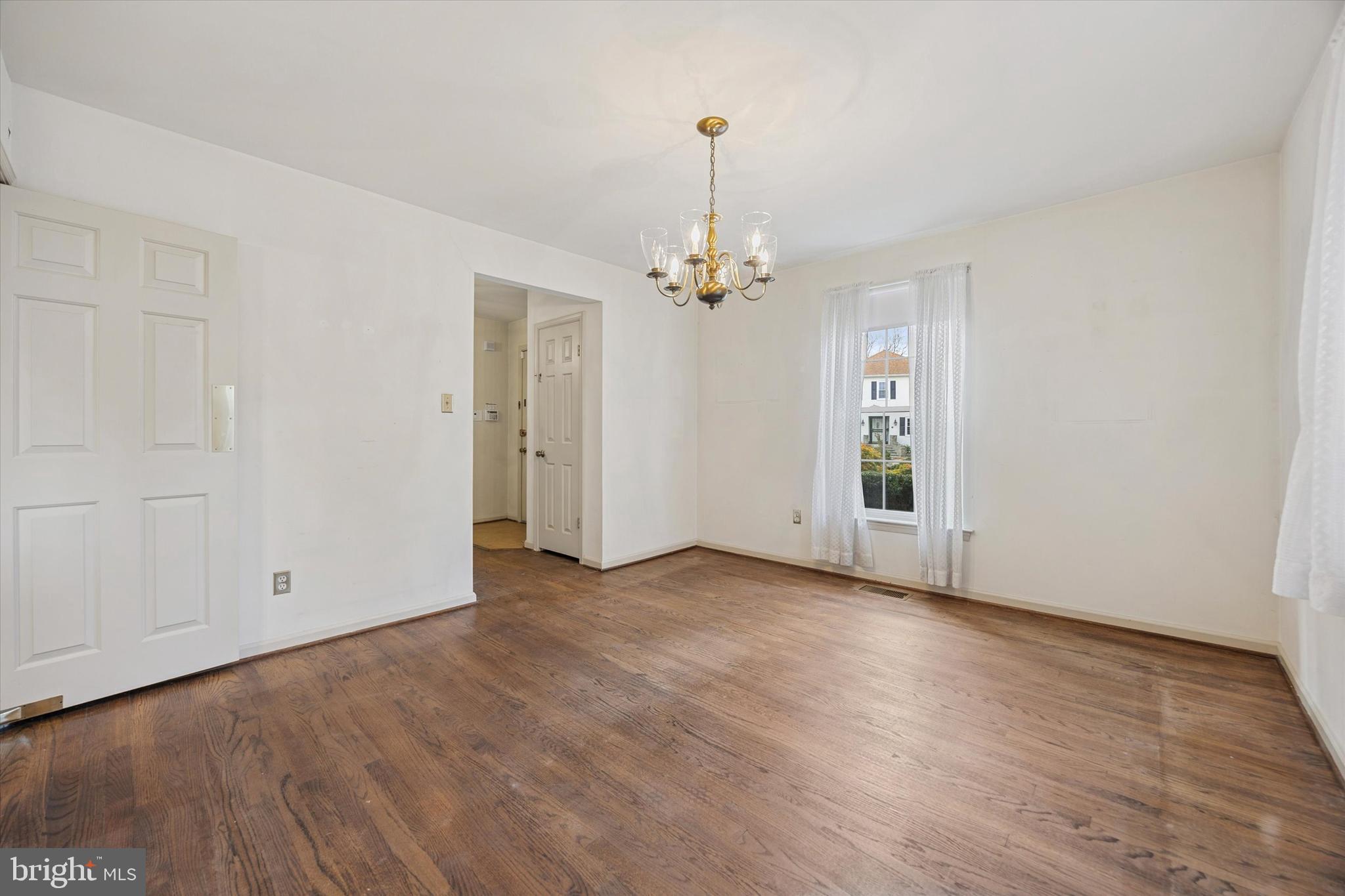 9 Hansen Court Narberth, PA 19072 - Photo 4 of 29 an empty room with wooden floor chandelier and closet