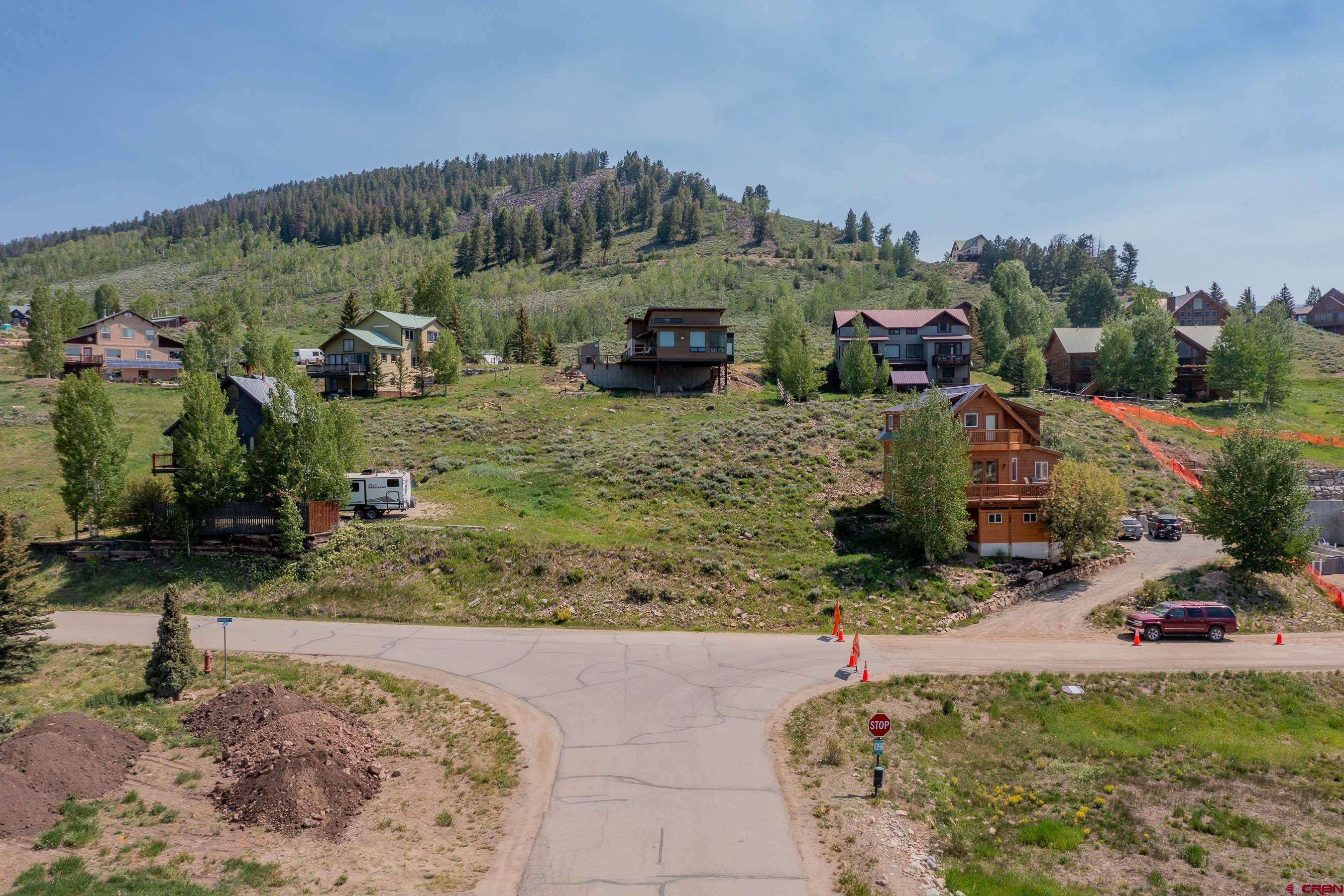 141 Haverly Street Crested Butte, CO 81224 - Photo 18 of 25 a backyard of a house with lots of green space