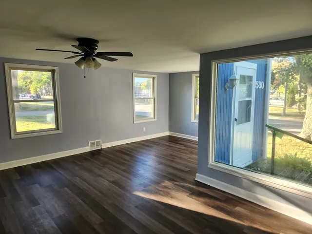 wooden floor in an empty room with a window