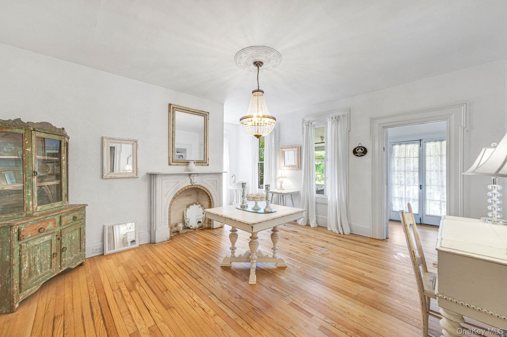 45 Shore Road East Setauket, NY 11733 - Photo 12 of 27 a bedroom with a bed and a chandelier