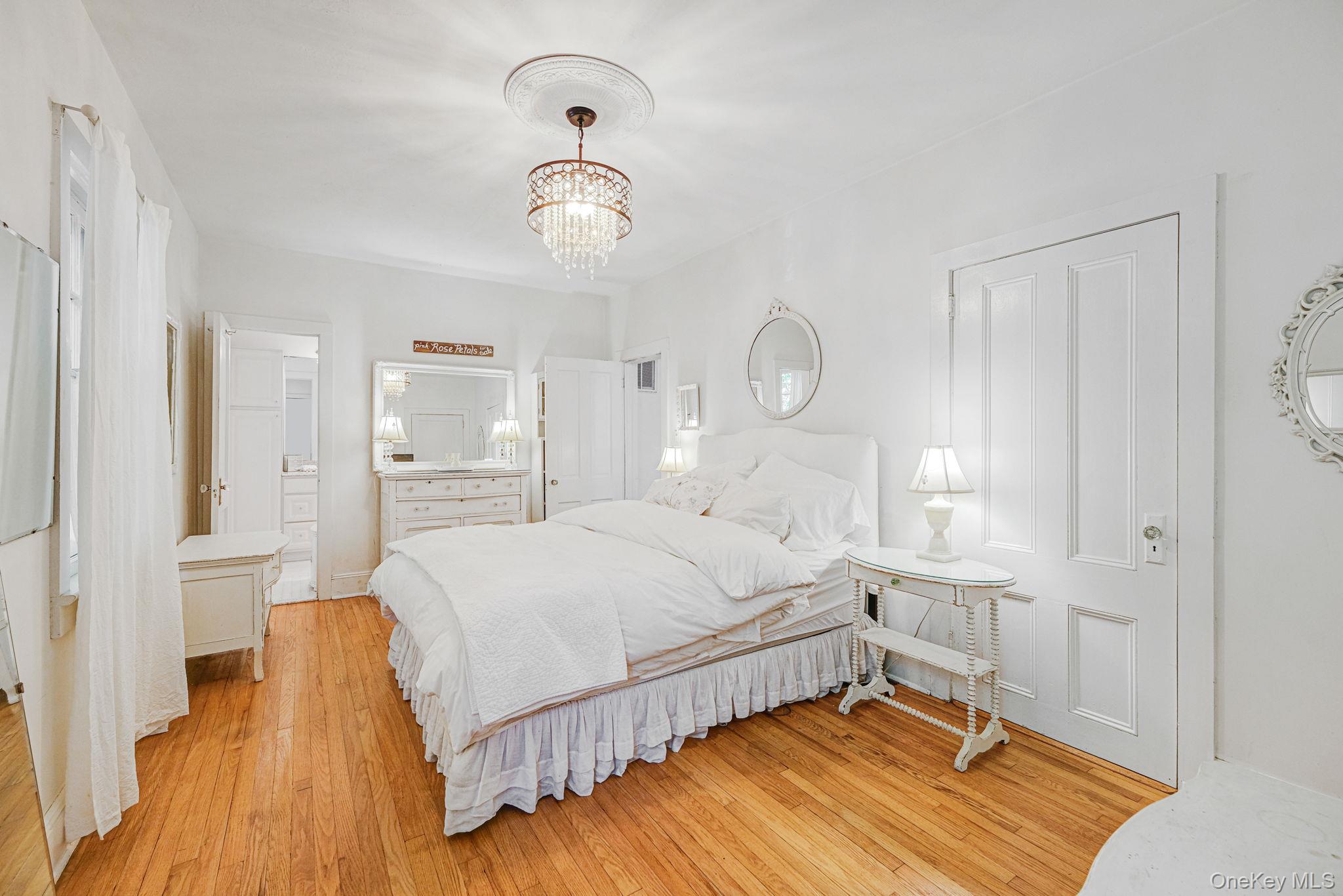 45 Shore Road East Setauket, NY 11733 - Photo 16 of 27 a bedroom with a bed and wooden floor