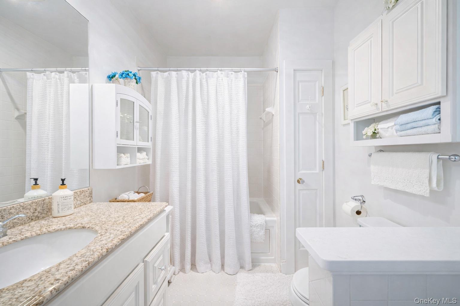 45 Shore Road East Setauket, NY 11733 - Photo 17 of 27 a bathroom with a granite countertop sink and a mirror