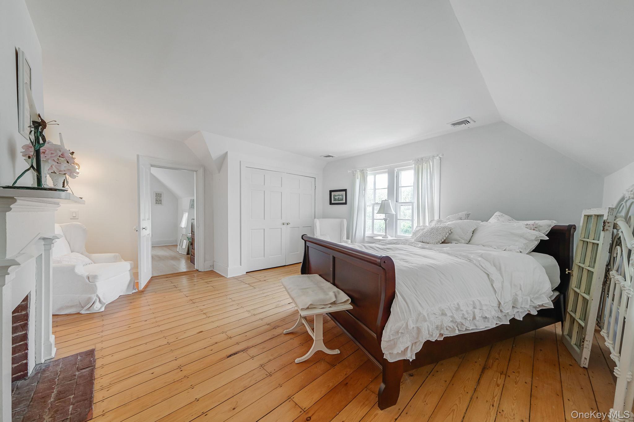 45 Shore Road East Setauket, NY 11733 - Photo 18 of 27 a bedroom with a bed and wooden floor