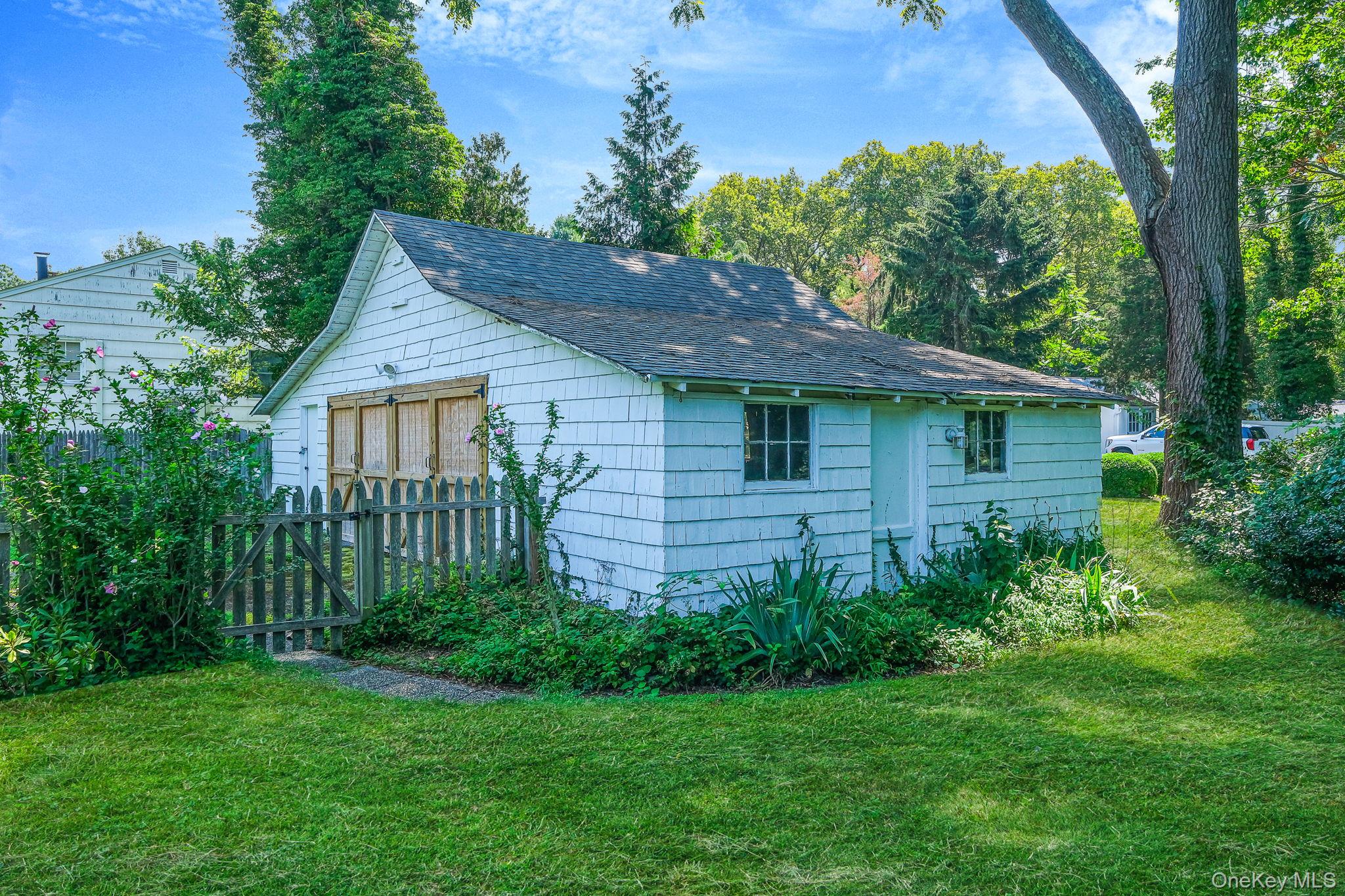 45 Shore Road East Setauket, NY 11733 - Photo 9 of 27 a view of a house with a yard plants and large tree