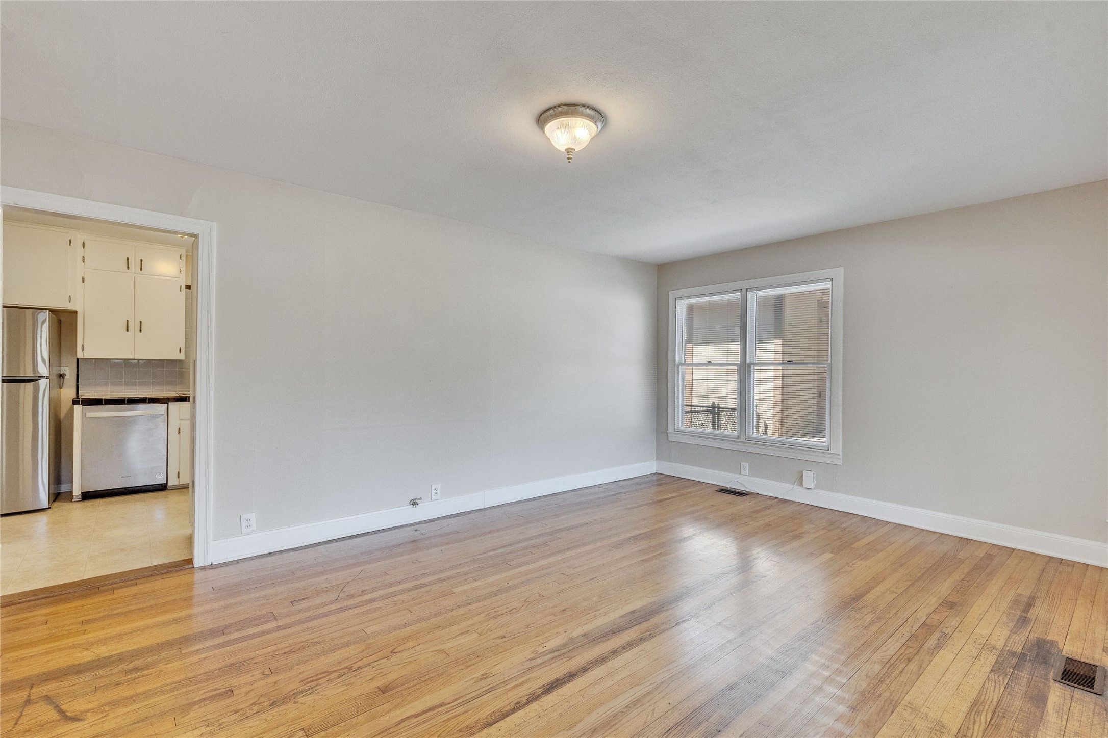 3810 Brookview Road Austin, TX 78722 - Photo 4 of 27 Rich hardwood floors and a classic double window define this versatile dining area.
