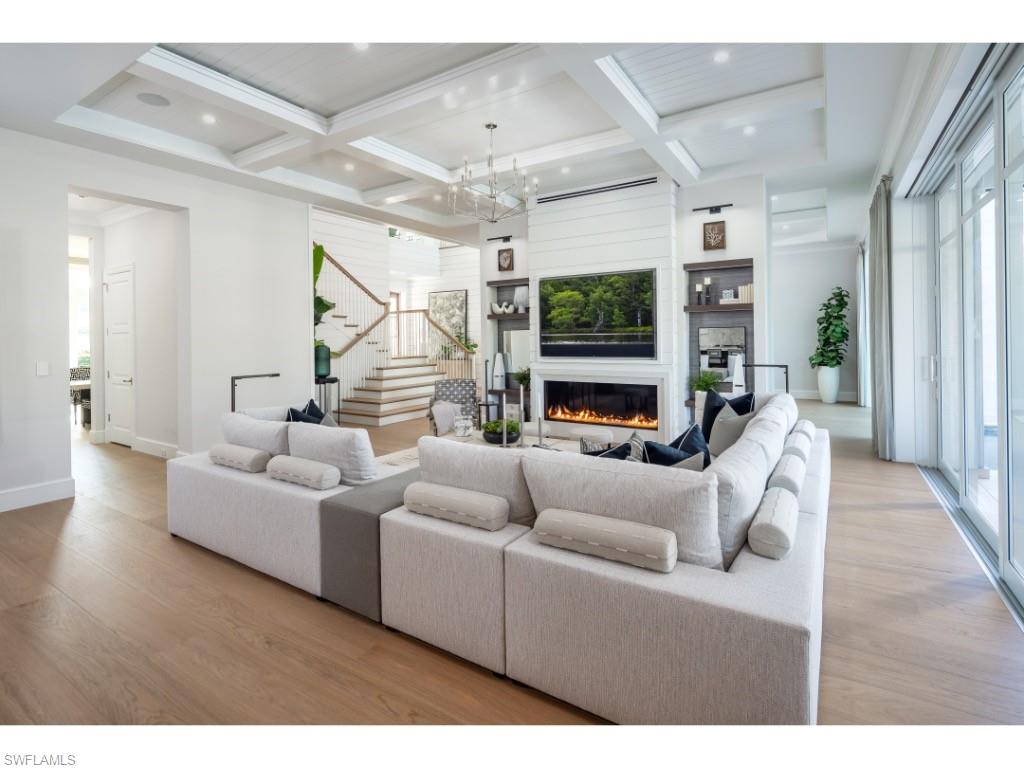 3200 Gin Lane Naples, FL 34102 - Photo 3 of 20 a living room with furniture and a flat screen tv
