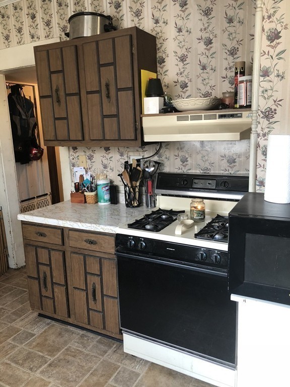 25 Hobson Street Springfield, MA 01109 - Photo 8 of 11 a stove top oven sitting inside of a kitchen