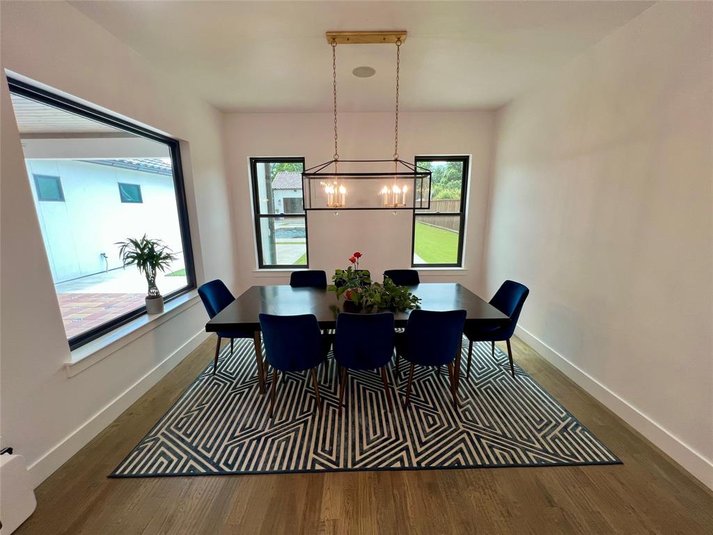 613 Wildcat Way Kennedale, TX 76060 - Photo 16 of 38 Dining area with a chandelier, wood finished floors, and baseboards