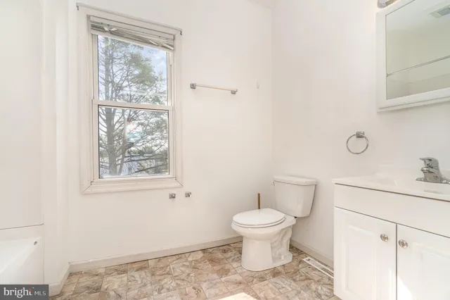 a white bath tub sitting next to a white wooden door