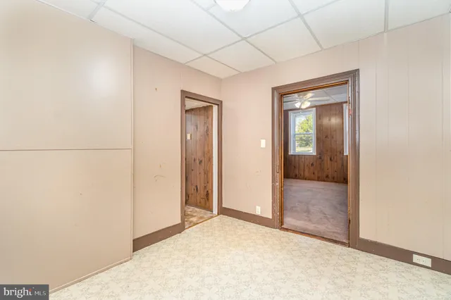 a kitchen with granite countertop a sink and wooden cabinets