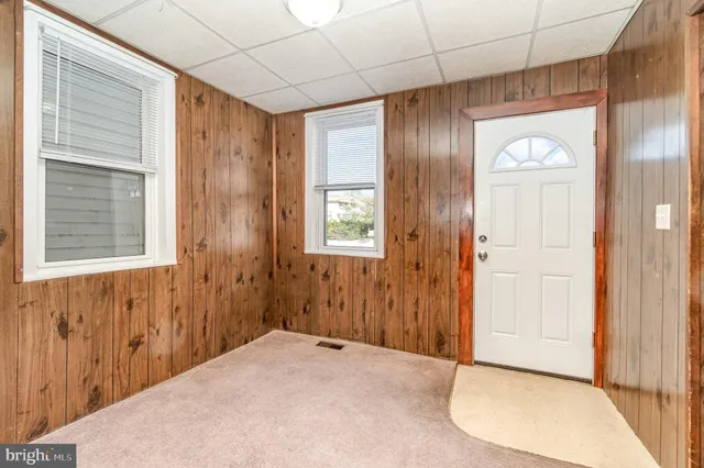 a view of a hallway with closet and window