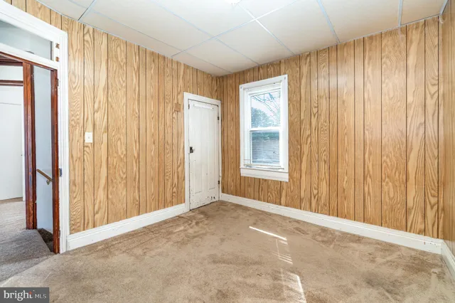 an empty room with a door and a curtain