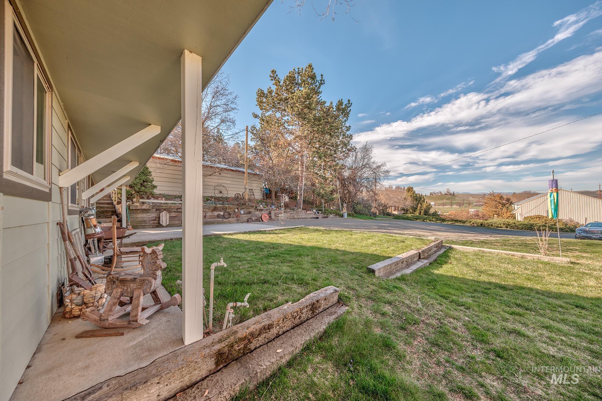 1365 Highway 95 Weiser, ID 83672 - Photo 15 of 34 View of grassy yard featuring covered porch