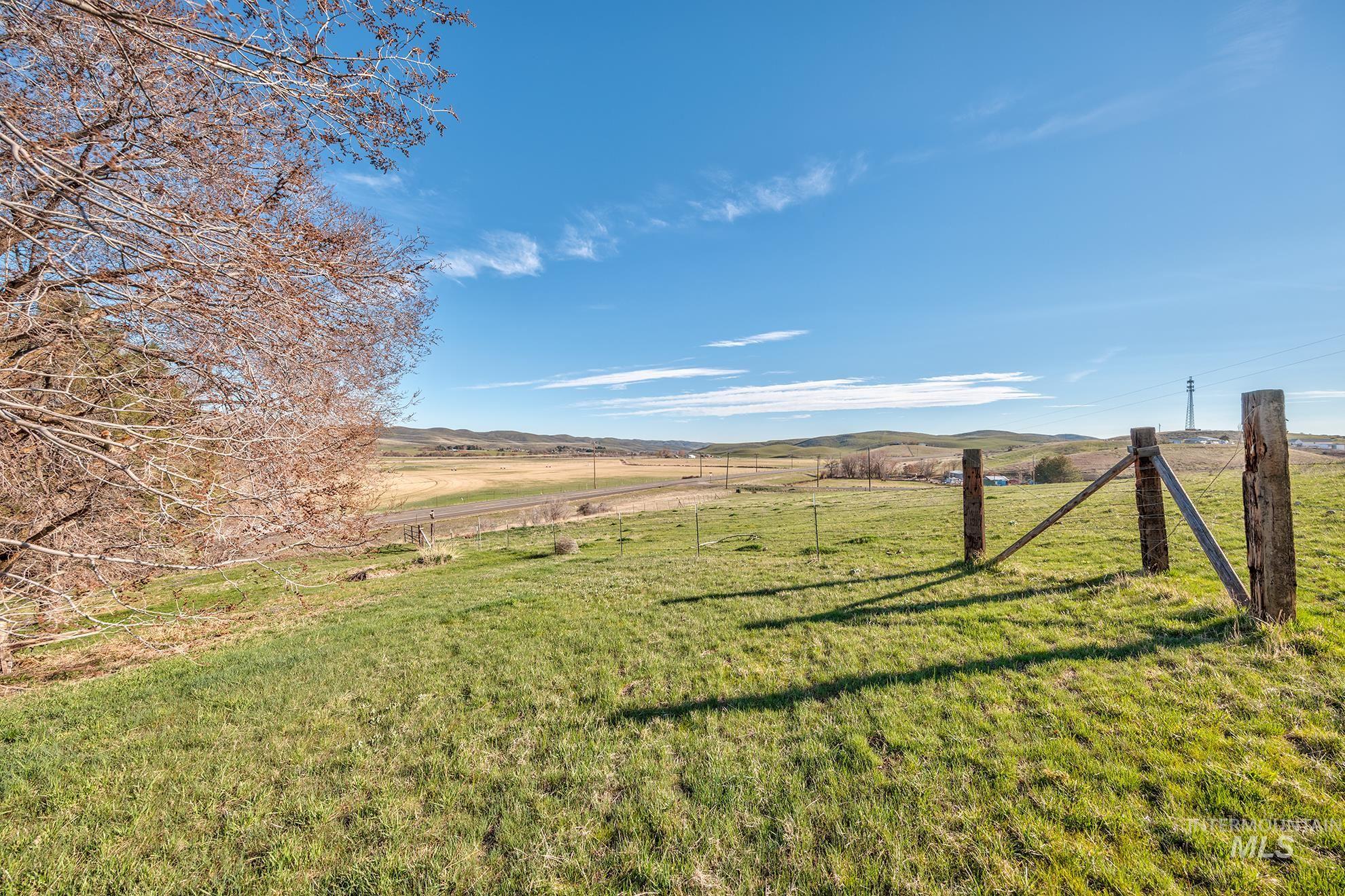 1365 Highway 95 Weiser, ID 83672 - Photo 21 of 34 View of green lawn featuring a rural view and a mountain view