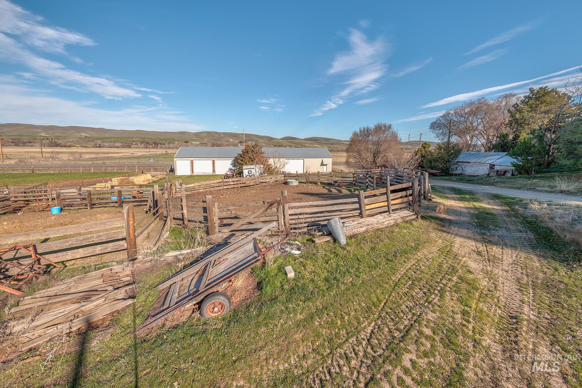 1365 Highway 95 Weiser, ID 83672 - Photo 26 of 34 View of yard with a view of rural / pastoral area, an outdoor structure, a detached garage, and a mountain view