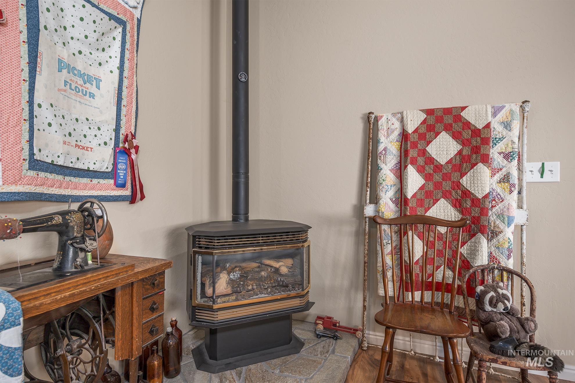 1365 Highway 95 Weiser, ID 83672 - Photo 5 of 34 Detailed view of a wood stove and wood finished floors