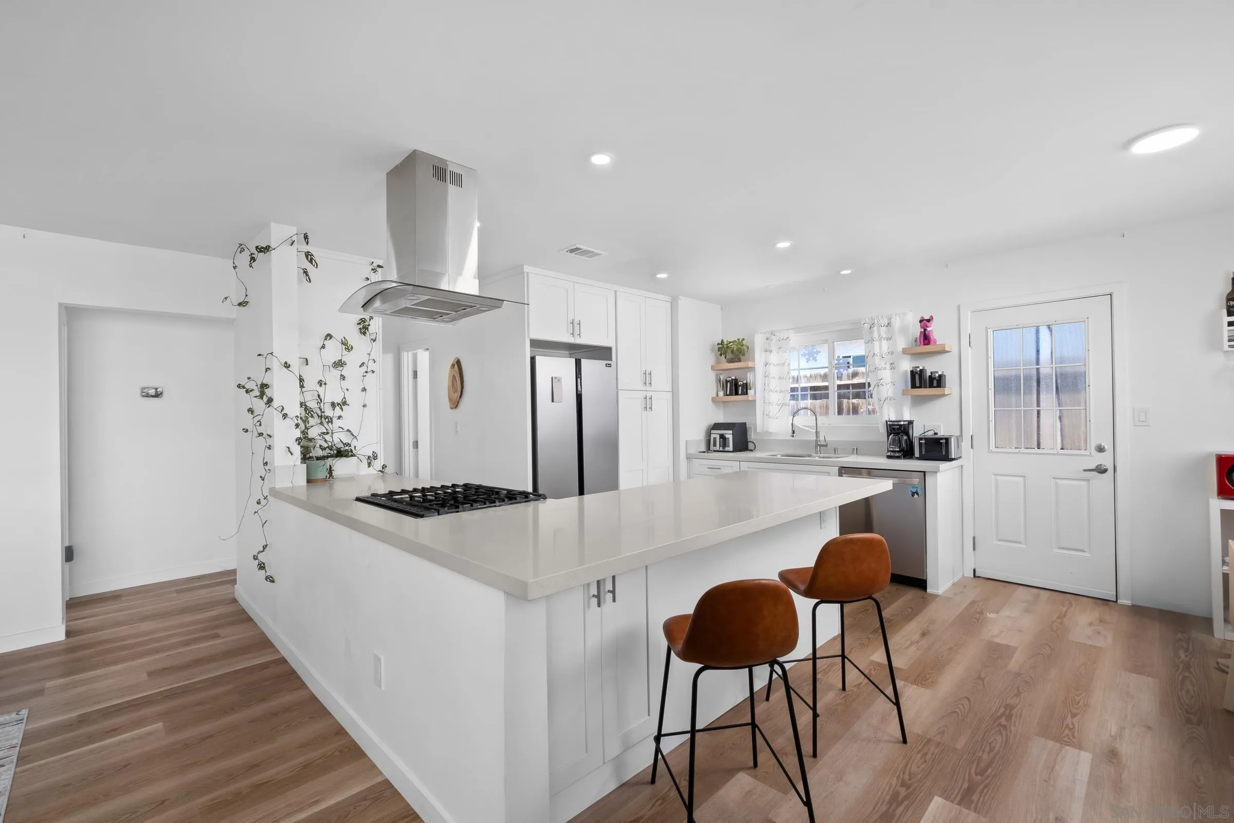 9651 Maccool Lane Santee, CA 92071 - Photo 12 of 32 a large white kitchen with stainless steel appliances granite countertop a stove and a refrigerator