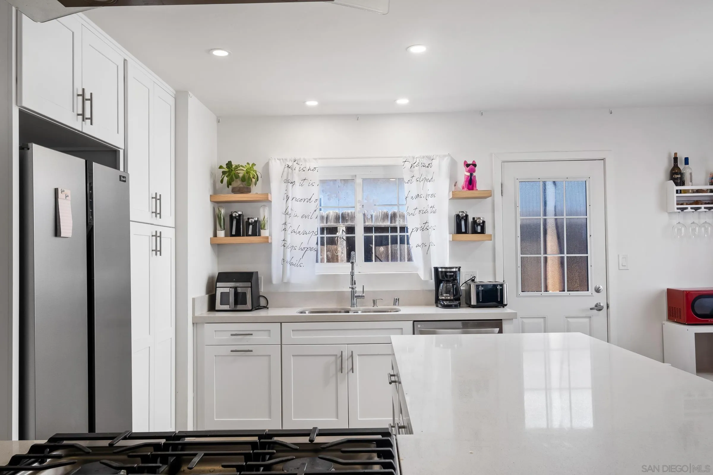9651 Maccool Lane Santee, CA 92071 - Photo 13 of 32 a kitchen with stainless steel appliances kitchen island granite countertop a refrigerator and a sink