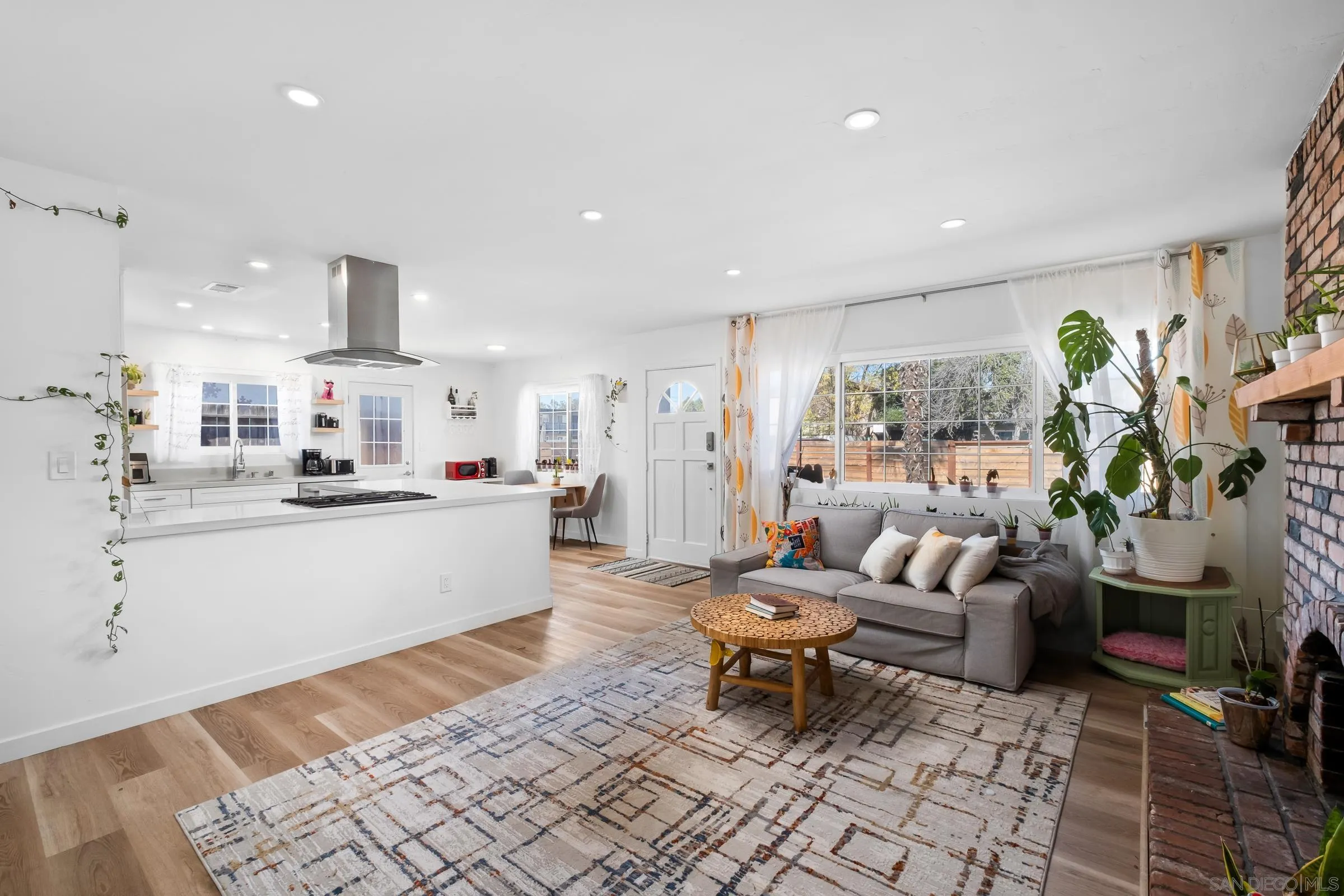 9651 Maccool Lane Santee, CA 92071 - Photo 17 of 32 a living room with furniture and a dining table with kitchen view