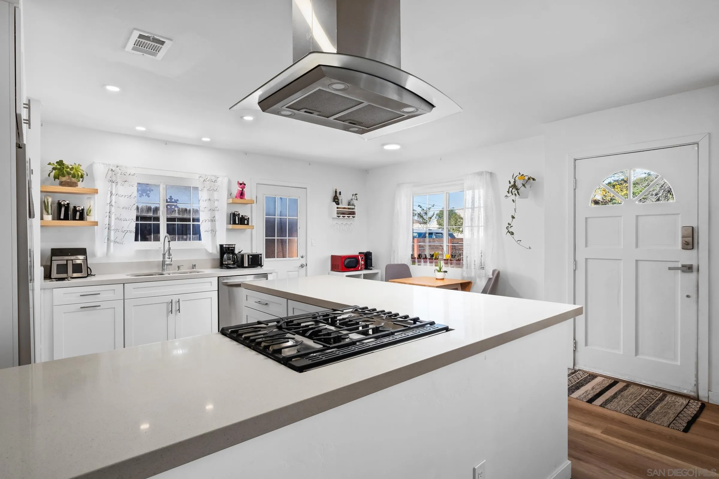 9651 Maccool Lane Santee, CA 92071 - Photo 18 of 32 a large kitchen with a stove a sink dishwasher and a refrigerator with wooden floor
