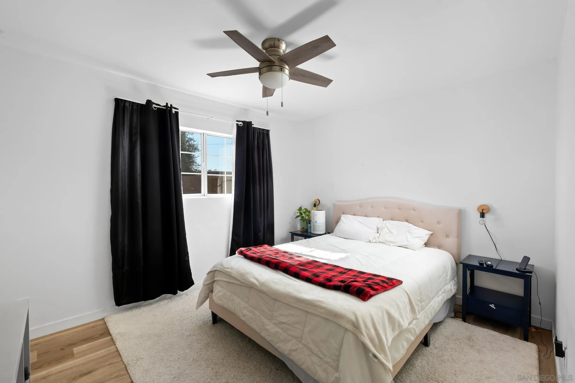 9651 Maccool Lane Santee, CA 92071 - Photo 22 of 32 a bedroom with a bed and a refrigerator