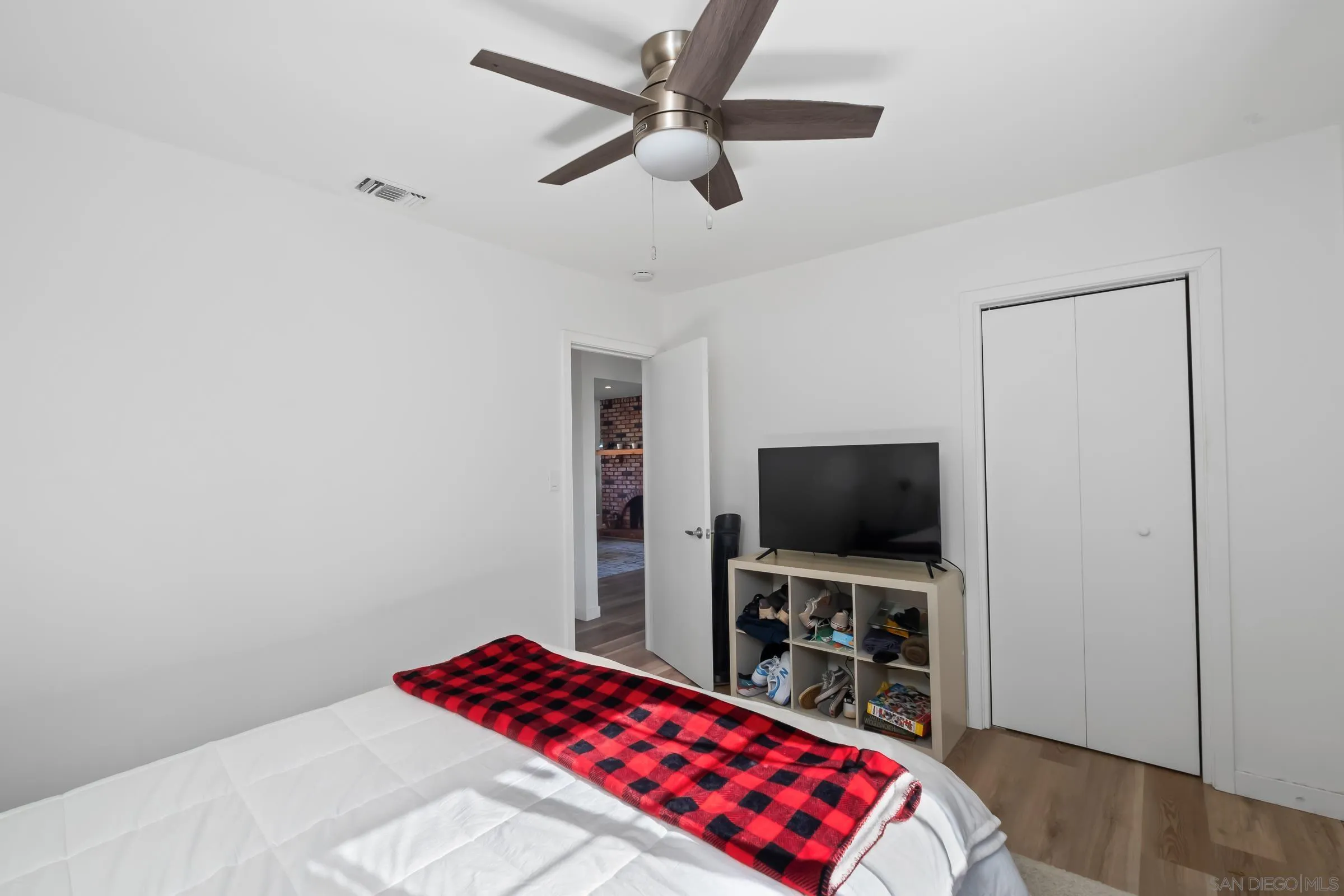 9651 Maccool Lane Santee, CA 92071 - Photo 23 of 32 a bedroom with a bed and a flat screen tv