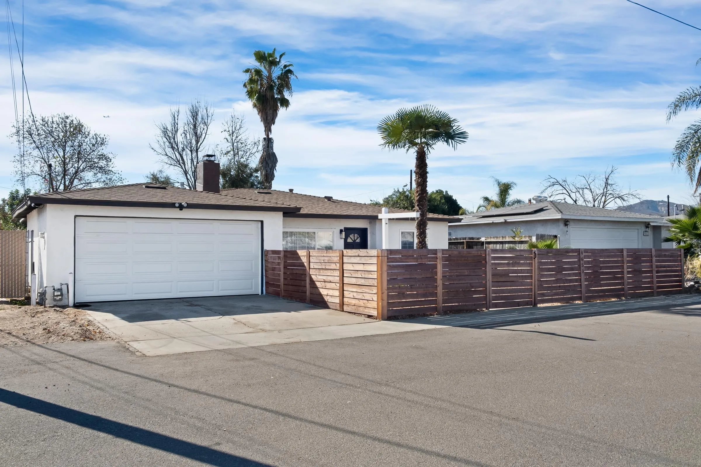 9651 Maccool Lane Santee, CA 92071 - Photo 3 of 32 a front view of a house with a garage