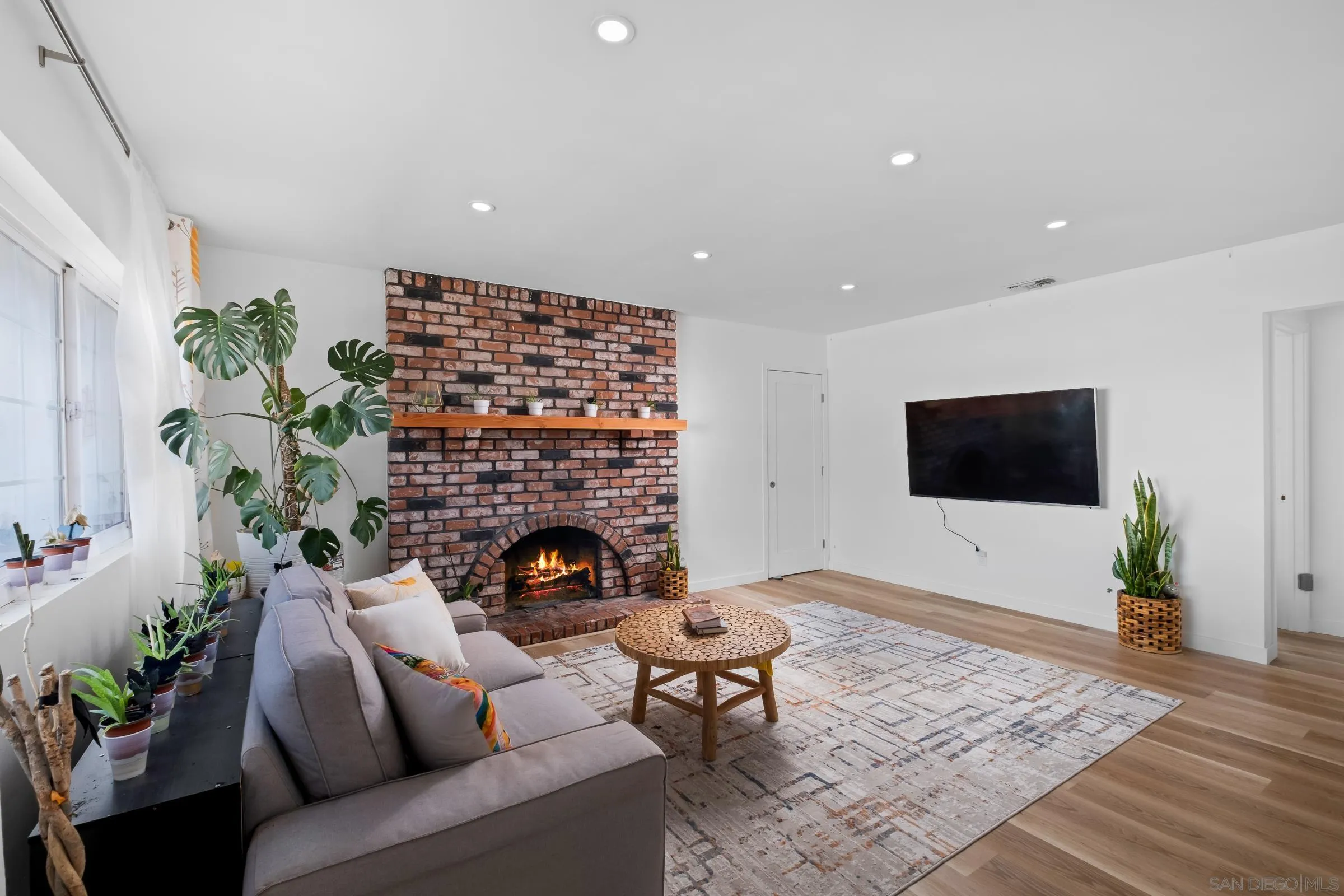 9651 Maccool Lane Santee, CA 92071 - Photo 9 of 32 a living room with furniture a flat screen tv and a fireplace