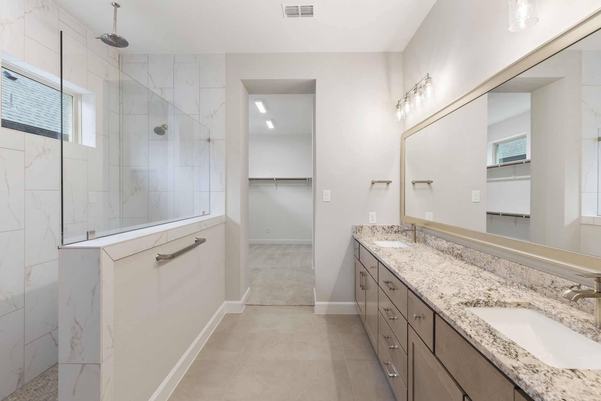 15834 Moran Meadow Street Conroe, TX 77302 - Photo 15 of 41 a bathroom with a granite countertop double vanity sink and mirror