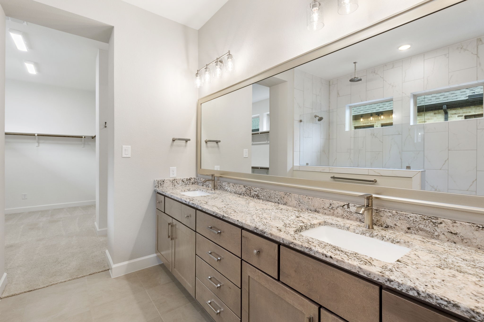 15834 Moran Meadow Street Conroe, TX 77302 - Photo 17 of 41 a bathroom with a granite countertop sink and a mirror