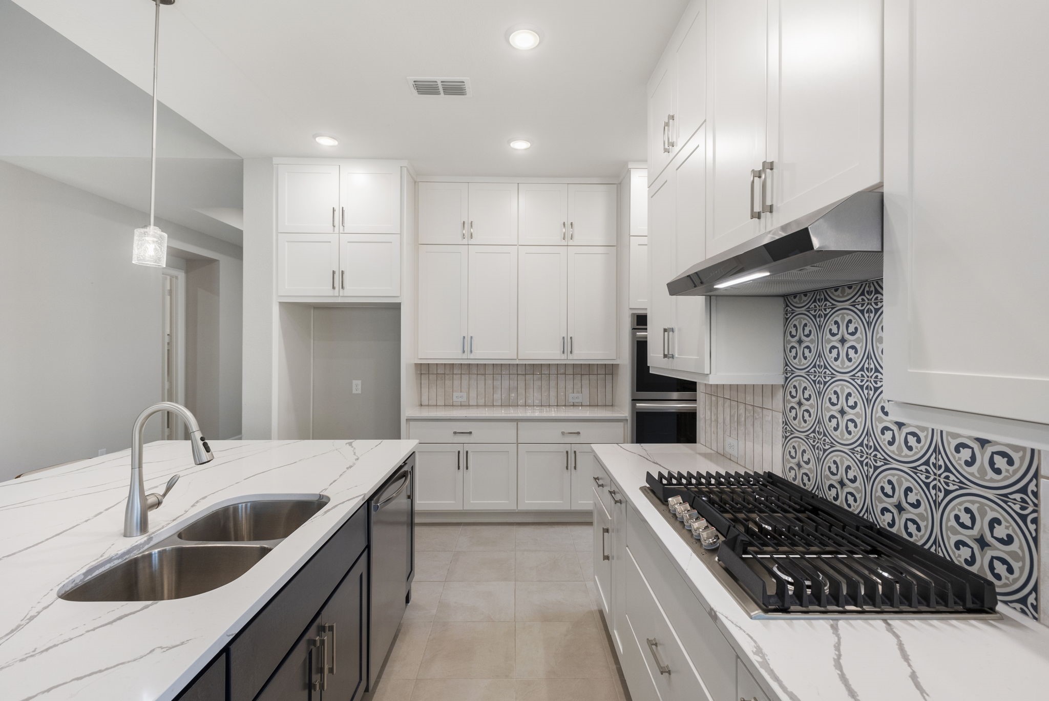15834 Moran Meadow Street Conroe, TX 77302 - Photo 7 of 41 a kitchen with a sink stove top oven and cabinets