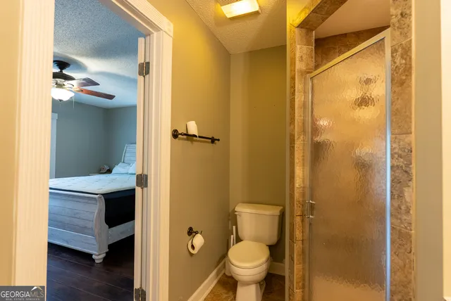 a bathroom with a toilet and a glass door
