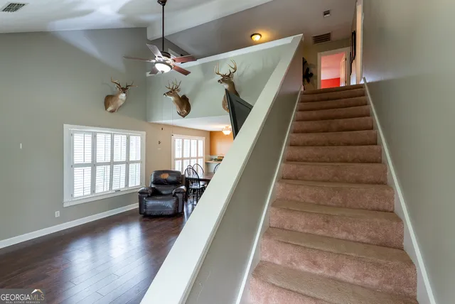 a view of entryway and hall with wooden floor