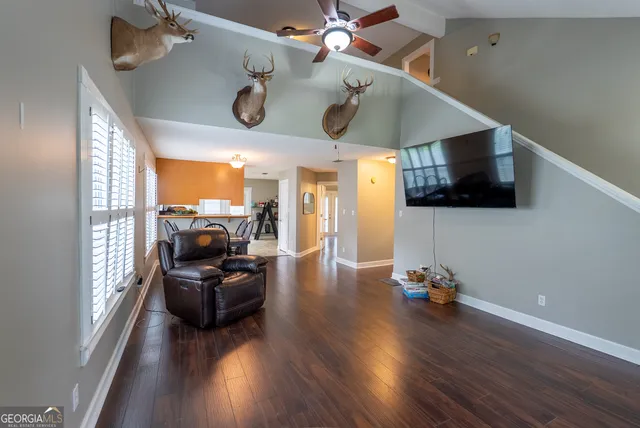 a view of a livingroom with furniture wooden floor and windows