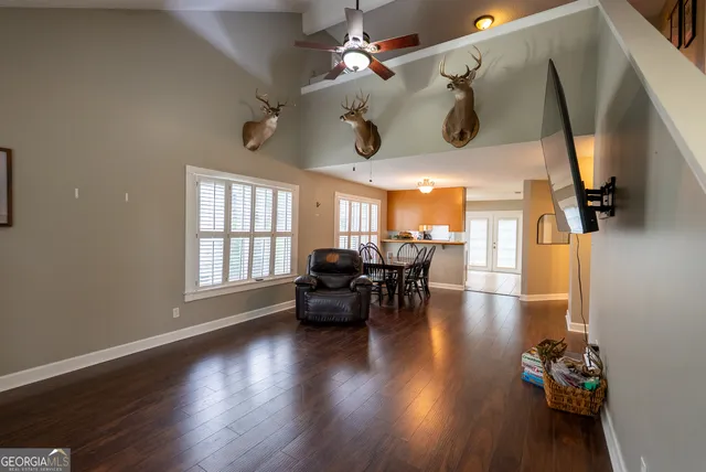 a dining room with wooden floor and chandelier