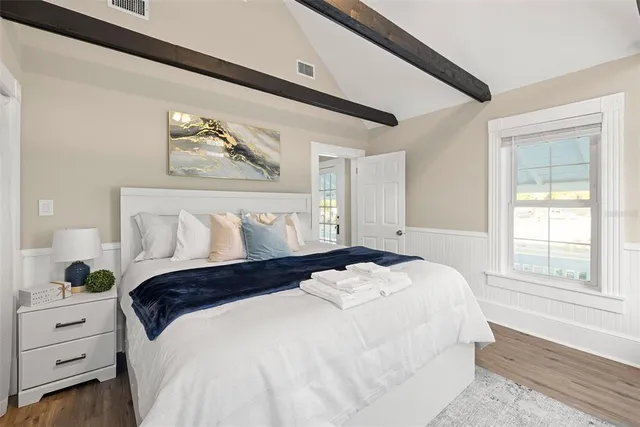 a bedroom with a bed and a window