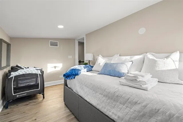 a bedroom with a bed and a lamp