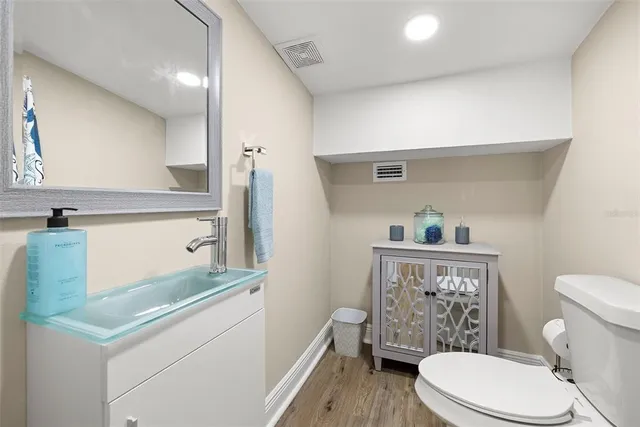 a white toilet sitting next to a bathroom sink