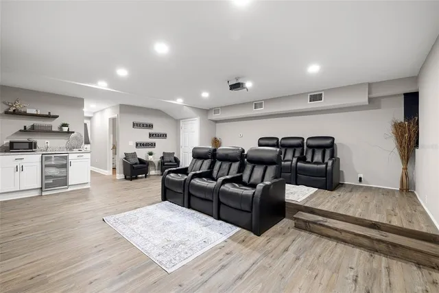 a living room with furniture and kitchen view