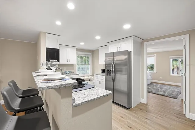 a kitchen with kitchen island a sink stove and refrigerator